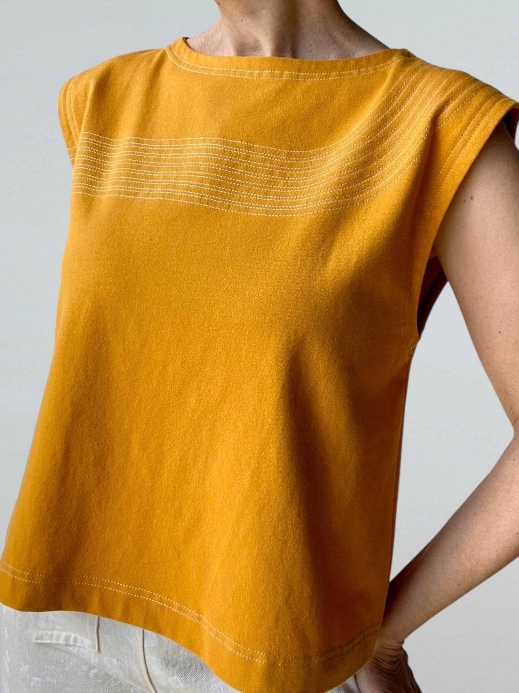 Shell Shirt in Gold with White Lines Stitching.